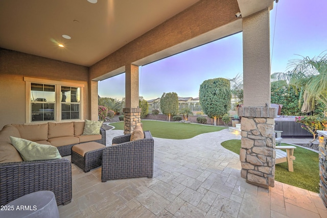 patio terrace at dusk featuring an outdoor hangout area and a yard