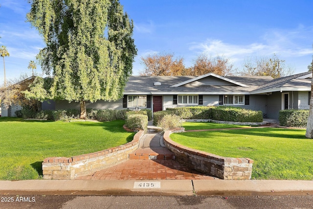 ranch-style home with a front lawn