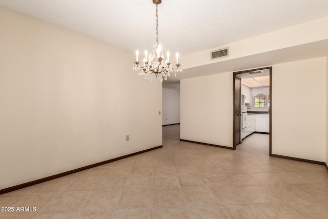 empty room featuring visible vents, a textured ceiling, baseboards, and an inviting chandelier