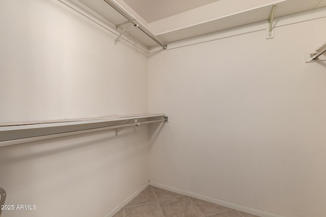 spacious closet featuring light tile patterned floors