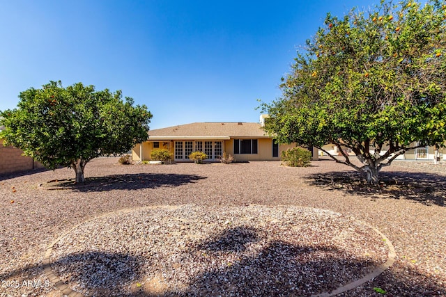 back of property with fence