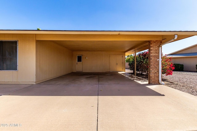 view of vehicle parking featuring an attached carport and concrete driveway