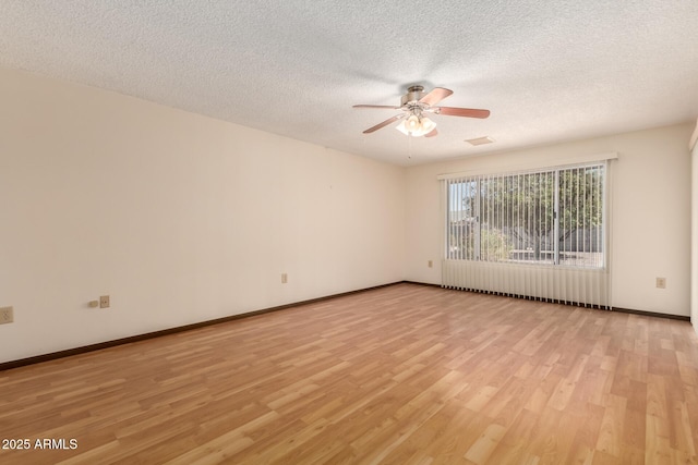 unfurnished room featuring visible vents, baseboards, ceiling fan, a textured ceiling, and light wood-type flooring