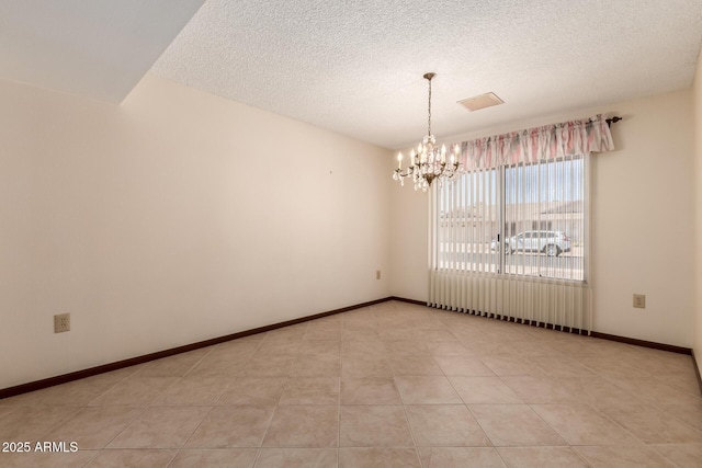 spare room featuring baseboards, light tile patterned floors, a textured ceiling, and an inviting chandelier