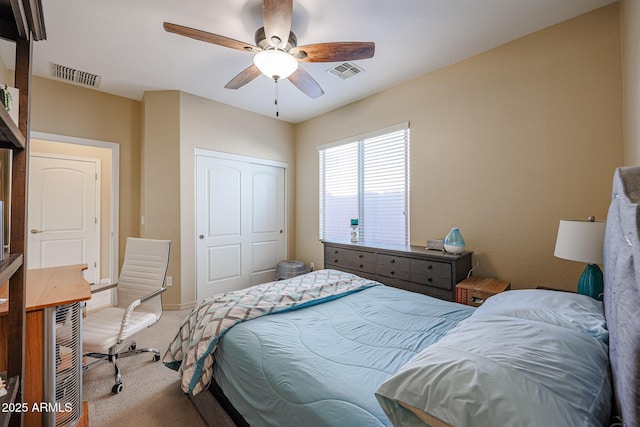 carpeted bedroom featuring ceiling fan and a closet