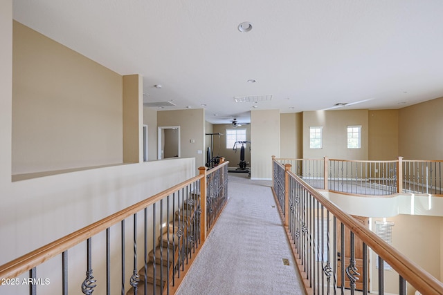 hallway featuring carpet and a healthy amount of sunlight