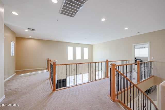 corridor with light colored carpet