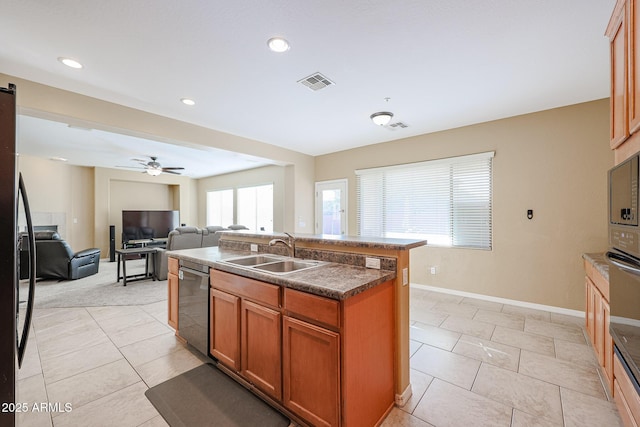 kitchen featuring stainless steel appliances, ceiling fan, sink, a center island with sink, and light tile patterned flooring