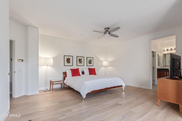 bedroom featuring connected bathroom, ceiling fan, and light hardwood / wood-style flooring