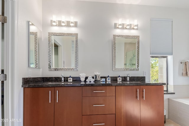 bathroom featuring a relaxing tiled tub and vanity