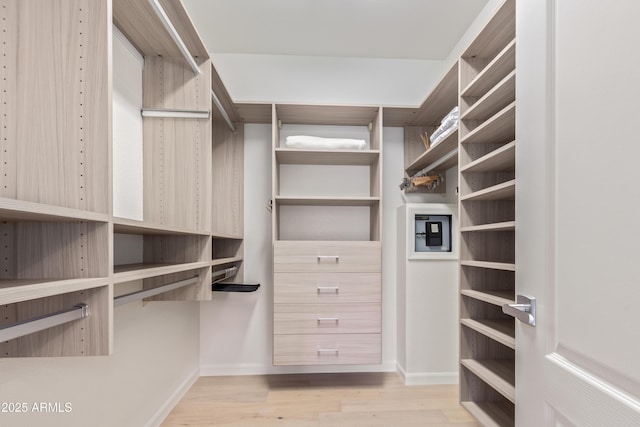 spacious closet featuring light hardwood / wood-style floors