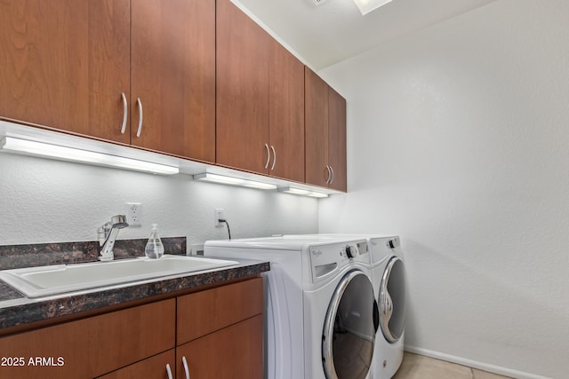 washroom featuring sink, cabinets, washer and clothes dryer, and light tile patterned floors