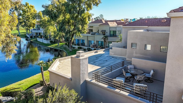 view of patio / terrace featuring a balcony and a water view