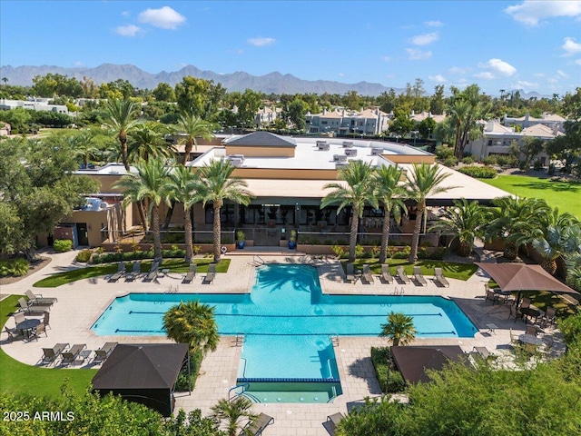 view of swimming pool with a patio and a mountain view