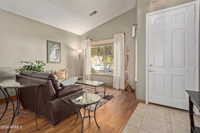 living room featuring light tile patterned flooring and lofted ceiling