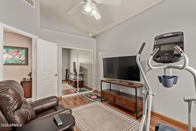 living room featuring ceiling fan, wood-type flooring, and vaulted ceiling