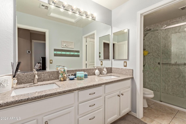 bathroom with tile patterned flooring, vanity, toilet, and a shower with door