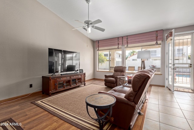 living room with light wood-type flooring, ceiling fan, and lofted ceiling