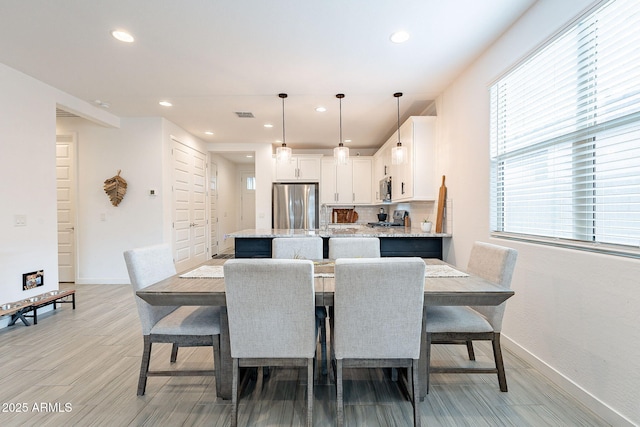 dining space featuring light wood-style flooring, recessed lighting, baseboards, and visible vents