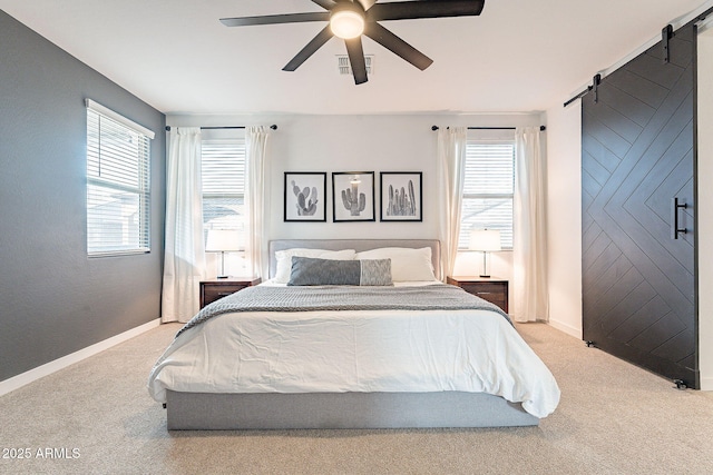 bedroom with visible vents, a barn door, carpet floors, baseboards, and ceiling fan