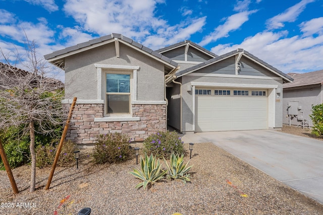 view of front of house with a tiled roof, an attached garage, driveway, and stucco siding