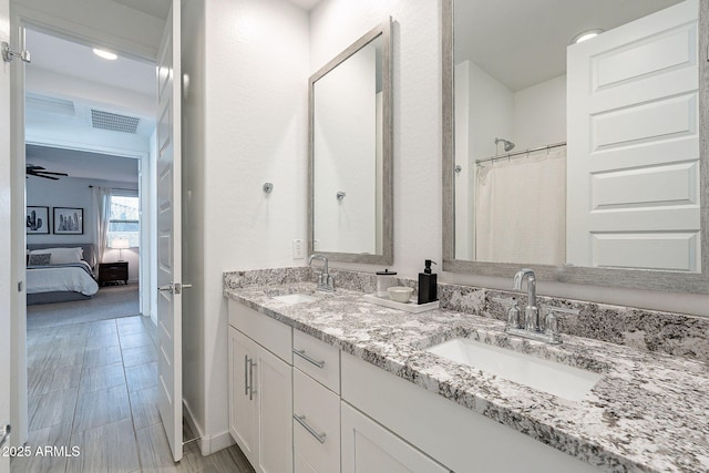 full bath with a sink, visible vents, ensuite bathroom, and double vanity