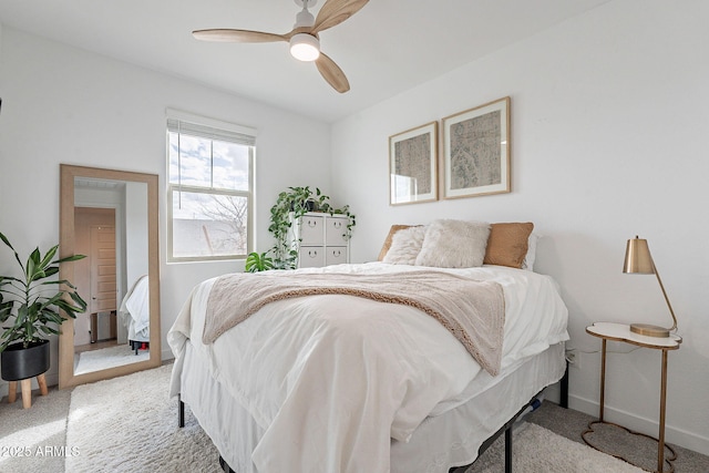 bedroom with a ceiling fan, baseboards, and carpet floors