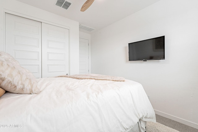 bedroom featuring visible vents, baseboards, a closet, and carpet flooring