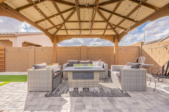 view of patio with a gazebo, an outdoor hangout area, and fence