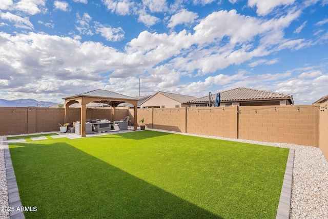 view of yard with a gazebo, an outdoor hangout area, a fenced backyard, and a patio area