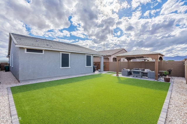 back of property featuring a gazebo, an outdoor hangout area, a fenced backyard, and a patio area