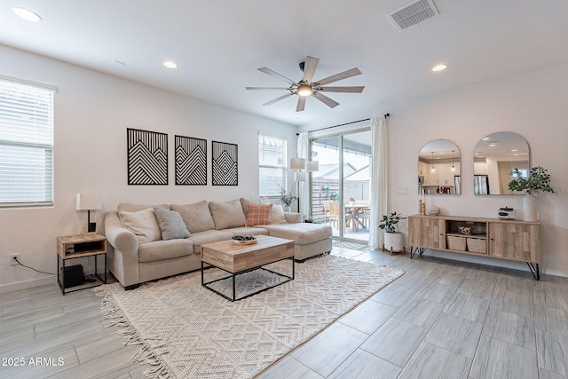 living room with recessed lighting, a ceiling fan, visible vents, and baseboards