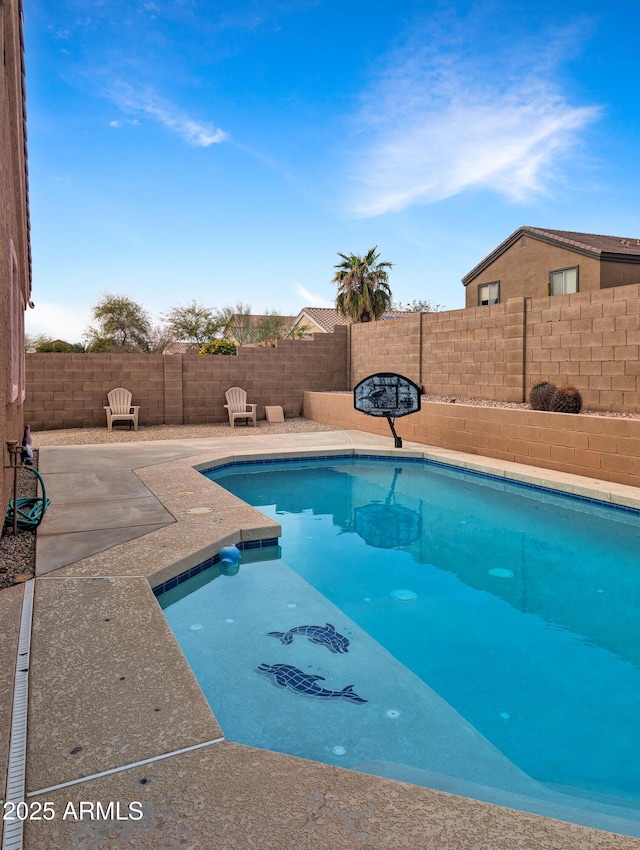 view of swimming pool featuring a patio area, a fenced backyard, and a fenced in pool