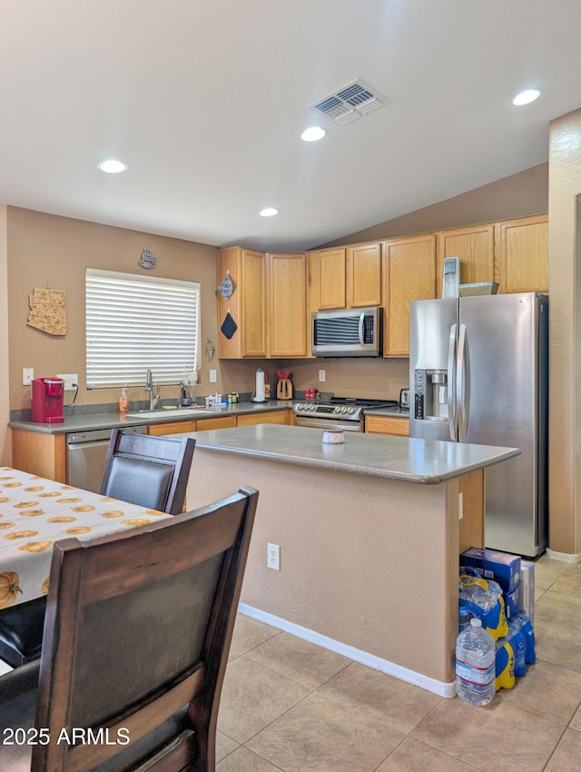 kitchen featuring recessed lighting, stainless steel appliances, a sink, visible vents, and a center island