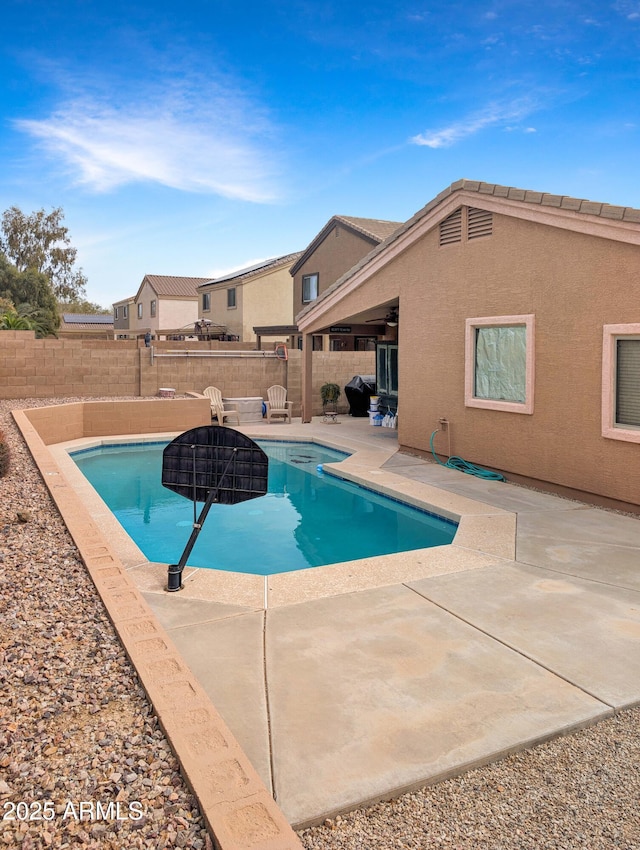 view of swimming pool featuring a patio area, a fenced backyard, and a fenced in pool