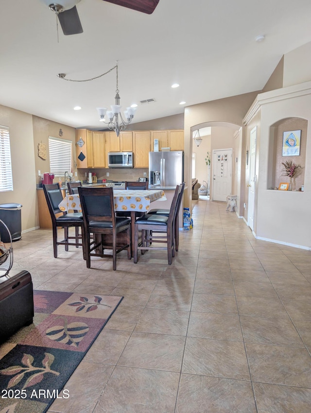 dining space with arched walkways, a chandelier, recessed lighting, visible vents, and baseboards