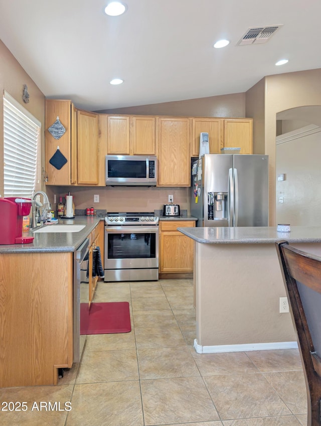 kitchen with light tile patterned floors, visible vents, appliances with stainless steel finishes, and a sink