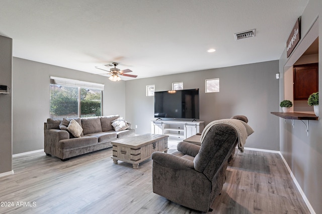 living room with ceiling fan and light wood-type flooring