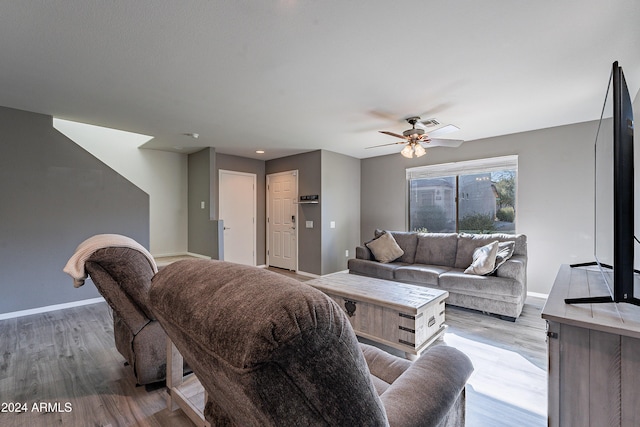 living room with light wood-type flooring and ceiling fan