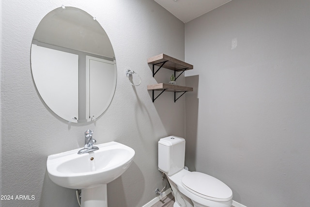 bathroom featuring sink and toilet