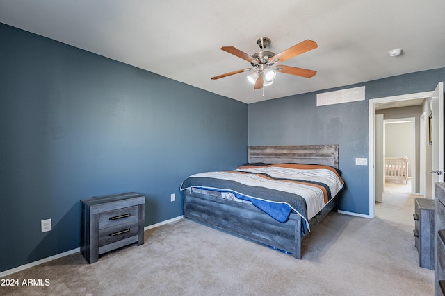 bedroom with ceiling fan and light carpet