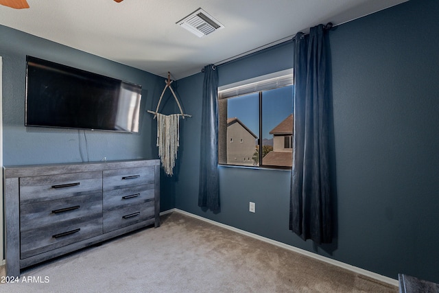 unfurnished bedroom with ceiling fan and carpet floors