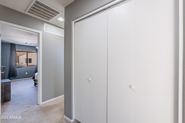 hallway featuring light colored carpet