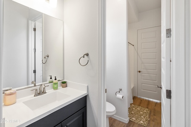 bathroom featuring vanity, wood-type flooring, and toilet