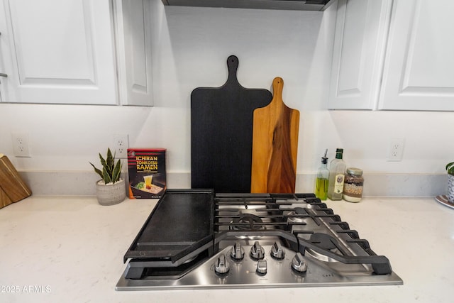 room details with white cabinetry and stainless steel gas cooktop