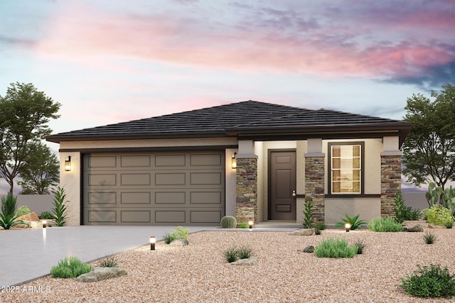 prairie-style home featuring stone siding, stucco siding, driveway, and a garage