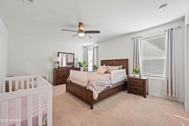 bedroom with ceiling fan and light colored carpet