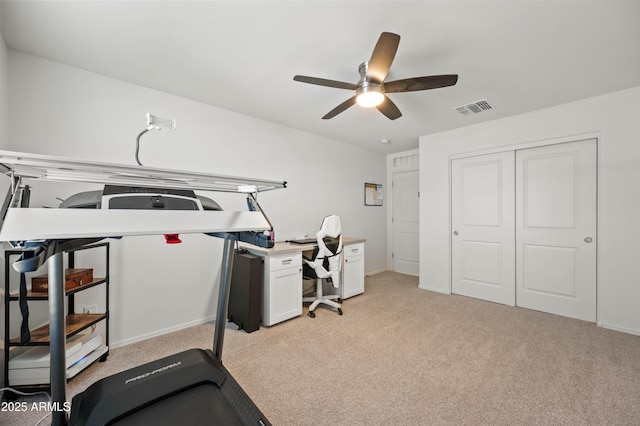 exercise area featuring ceiling fan and light colored carpet