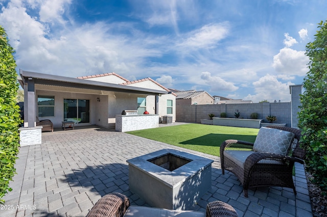 view of patio featuring central AC unit and a fire pit