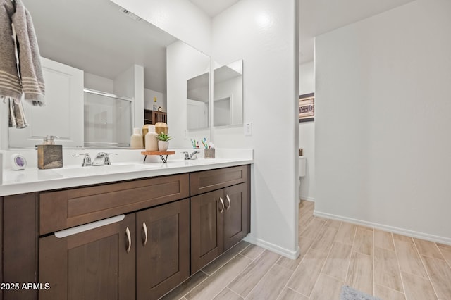 bathroom with walk in shower and vanity